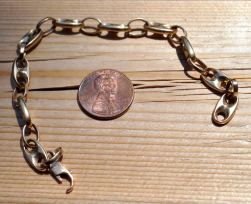 gold bracelet and Lincoln cent