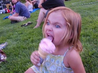 child licking ice cream cone